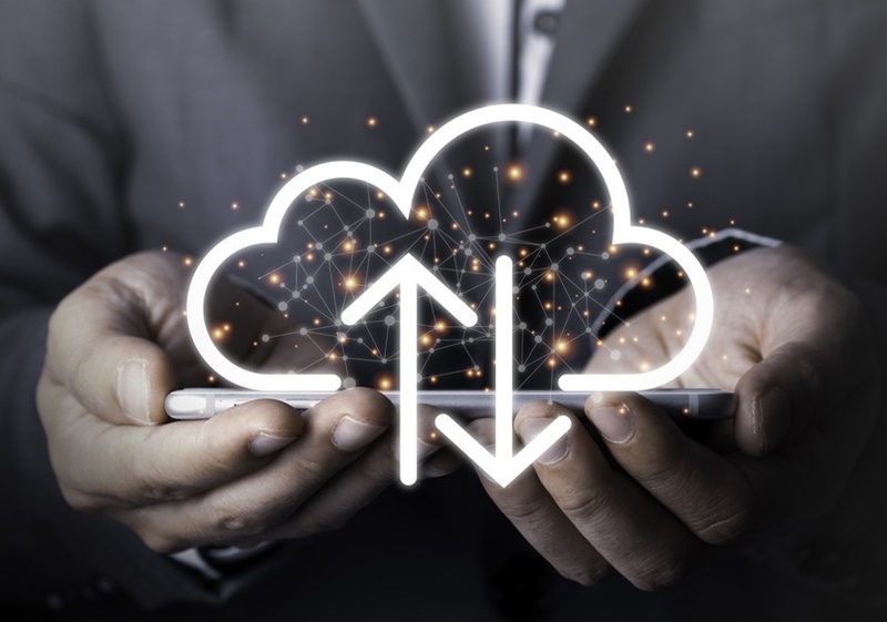 Businessman holding mobile phone which on the top of phone has upload and download cloud space computer.Technology and data information transfer concept.